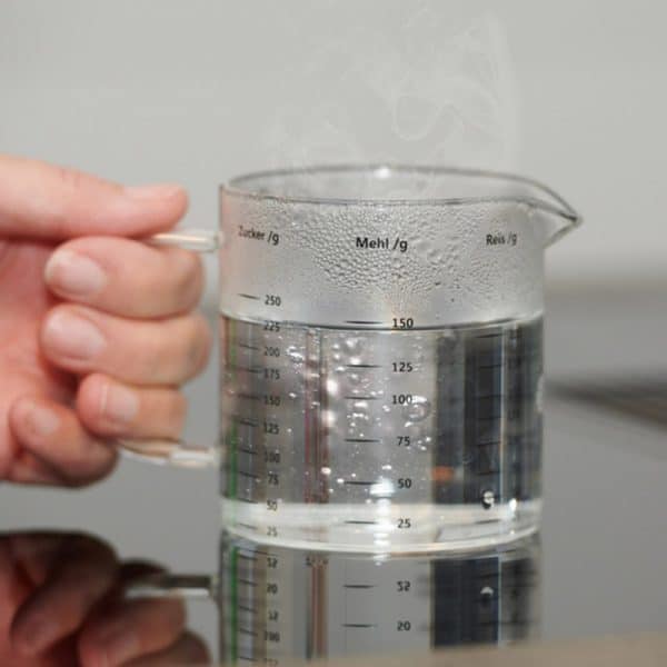 Glass measuring cup filled with water