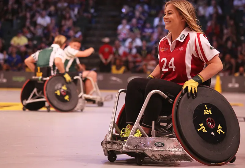 Happy wheelchair user playing sports