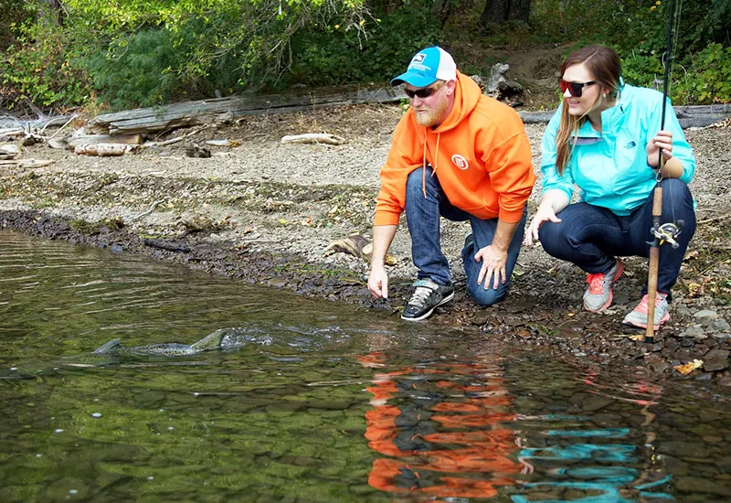 A pair of anglers releases a fish they caught